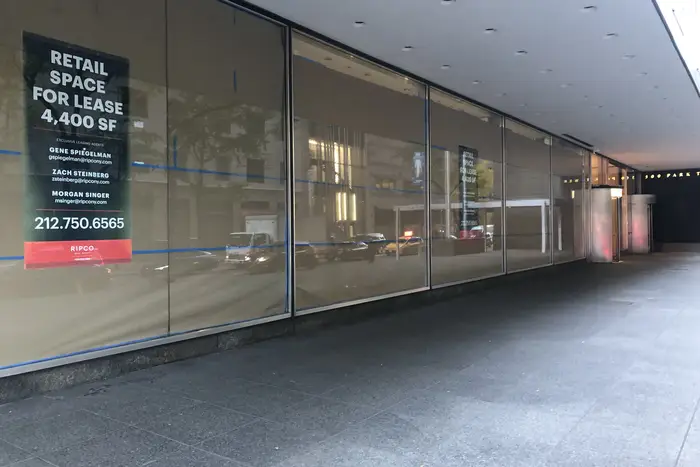 Large empty showroom retail space for lease sign, Manhattan, New York.